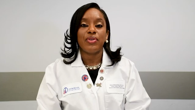 image of a black female physician with shoulder length black hair wearing a lab coat