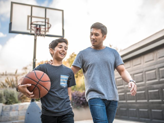 Dad and son playing basketball