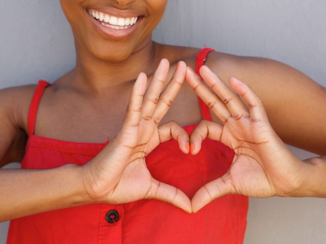 Woman making heart symbol with hands