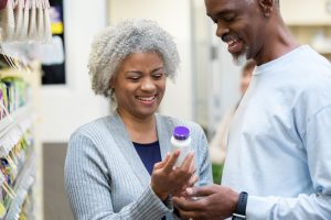 Older couple examining medicine off the shelf