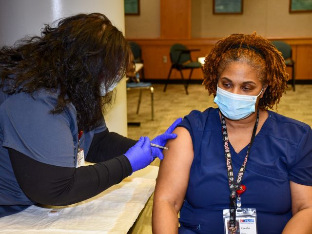 Environmental Services employee Keesha Wilburn receives her second vaccine dose.