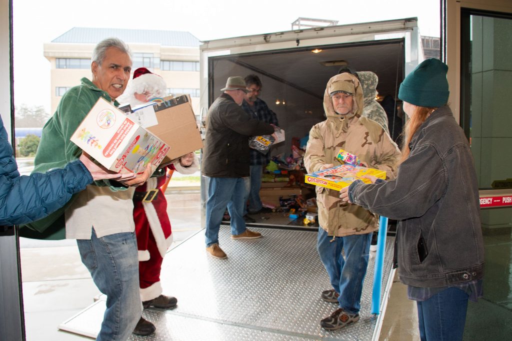 Unloading the truck and passing the toys down the line.