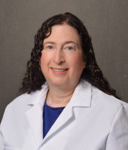 female physician with curly brown hair