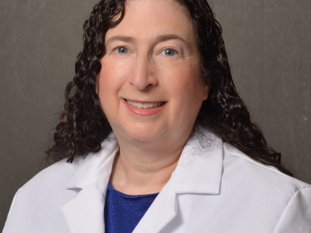 female physician with curly brown hair