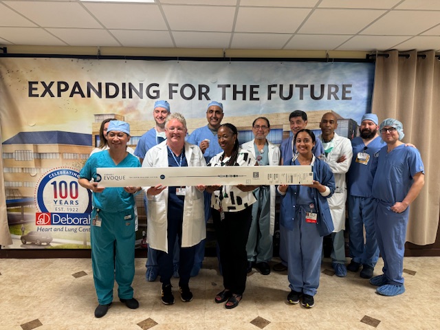 group of physicians holding a sign