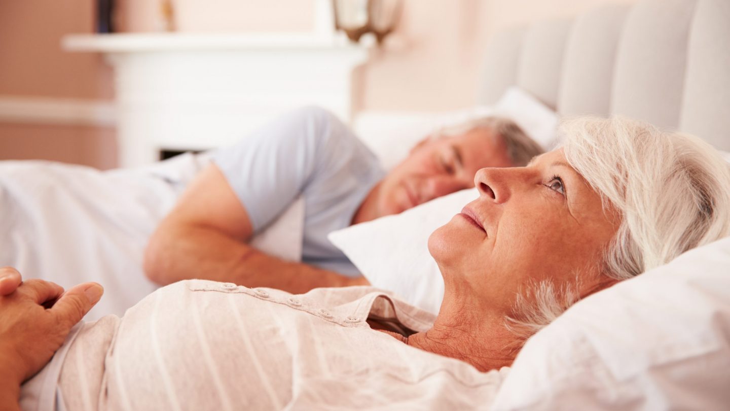 Worried Senior Woman Lying Awake In Bed