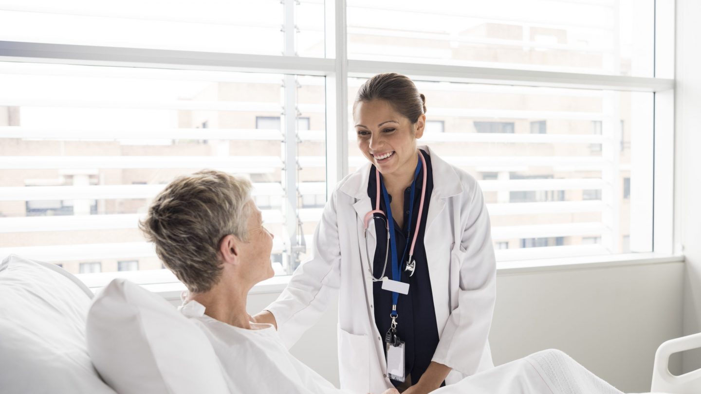 Female consultant smiling and talking with patient