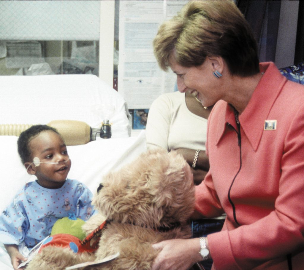 Governor Whitman with child and teddy bear