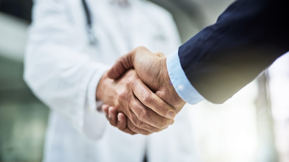 Doctor Shaking Hands with Business Man