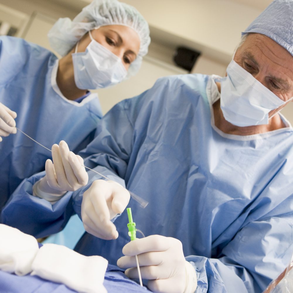 Surgeons Preparing Equipment For Surgery Wearing Hospital Mask Concentrating