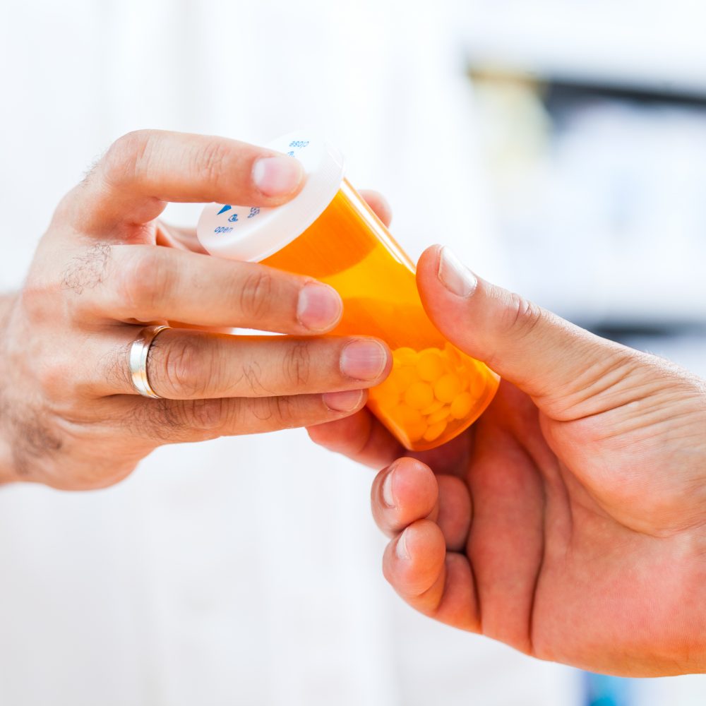Pharmacist giving pills to customer