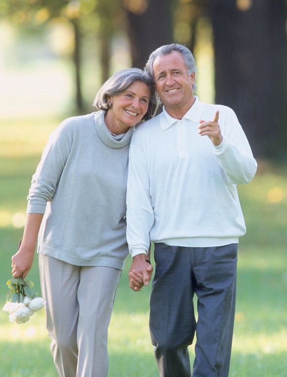 Older couple walking together in a park