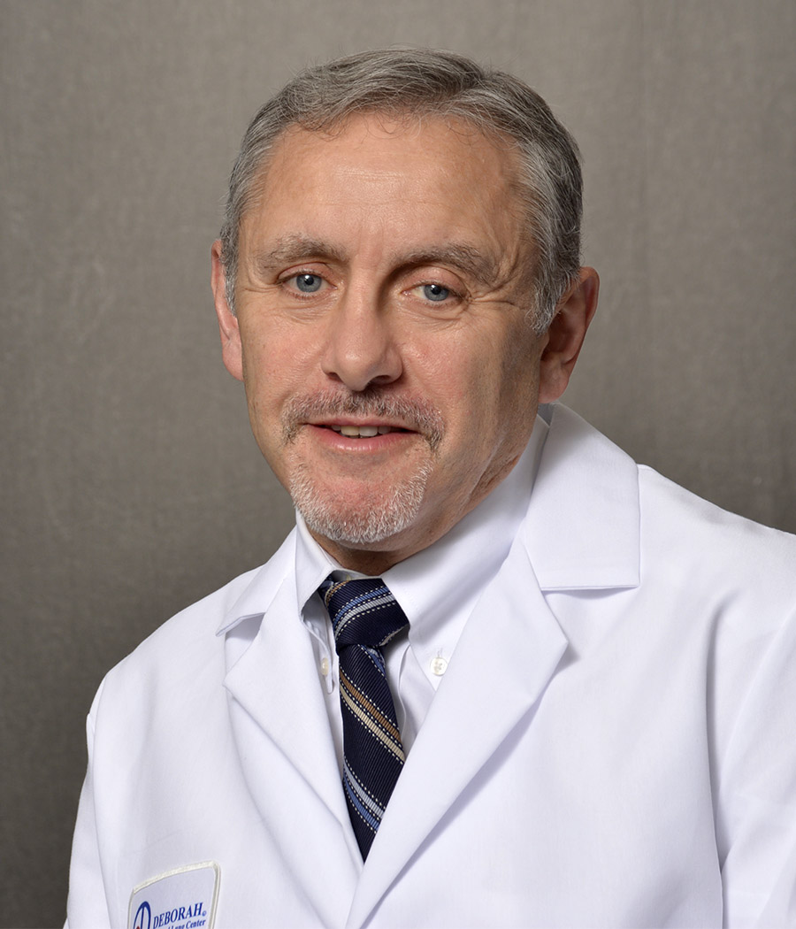 male physician wearing dark rimmed glasses and lab coat
