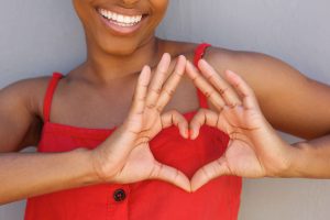 Woman making heart symbol with hands
