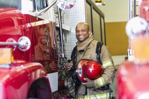 fire fighter standing next to truck
