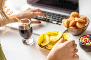 Woman snacking on junk food