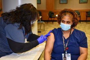 Environmental Services employee Keesha Wilburn receives her second vaccine dose.