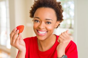 Woman eating strawberry