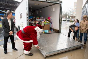 Deborah President and CEO Joseph Chirichella (left), Santa, and High-Octane South Jersey founder Chris Scafario open the toy donation truck.