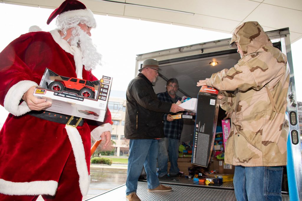 Unloading the truck and passing the toys down the line.