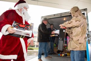 Unloading the truck and passing the toys down the line.