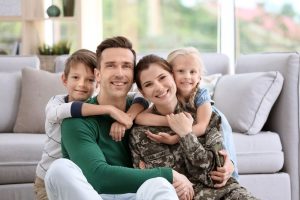 Woman in military uniform with her family at home