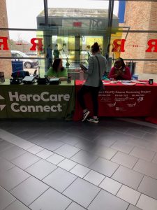 woman stands at herocare connect booth