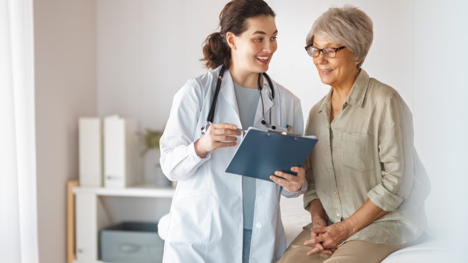 Female patient listening to a doctor in hospital.
