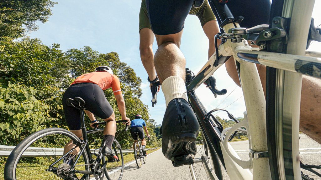 point of view male cyclist competing in sports race cycling event at rural scene