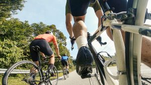 point of view male cyclist competing in sports race cycling event at rural scene