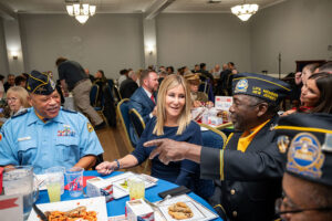 man at veterans day event saluting