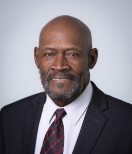 headshot of black man in suit and tie