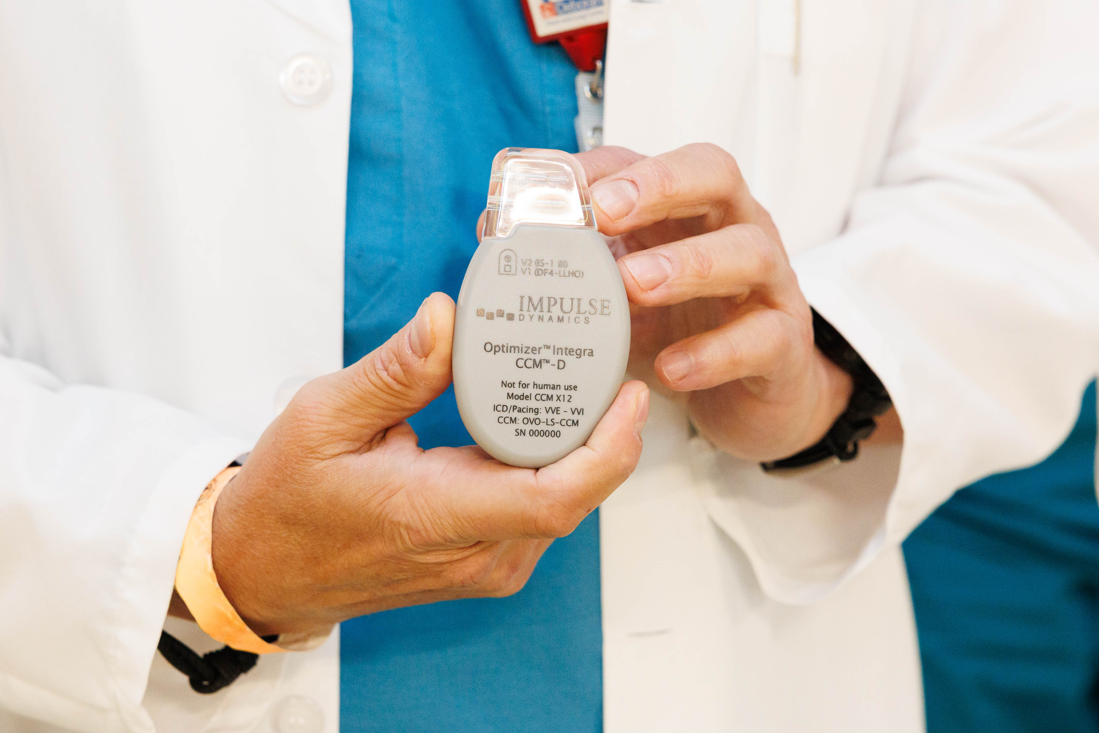 hands holding Optimizer™ Integra-D device