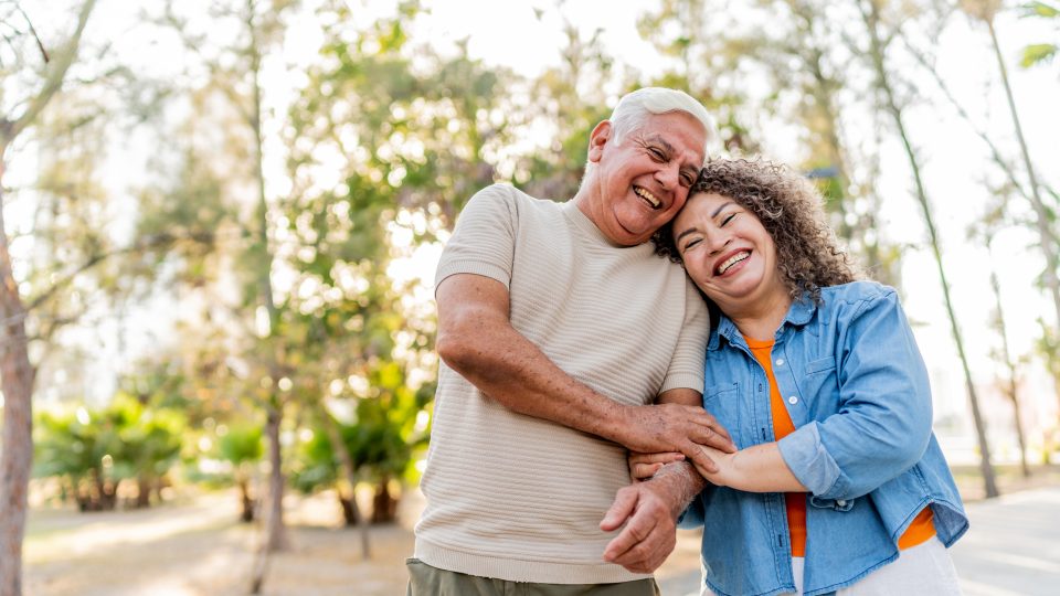 Senior couple walking on public park