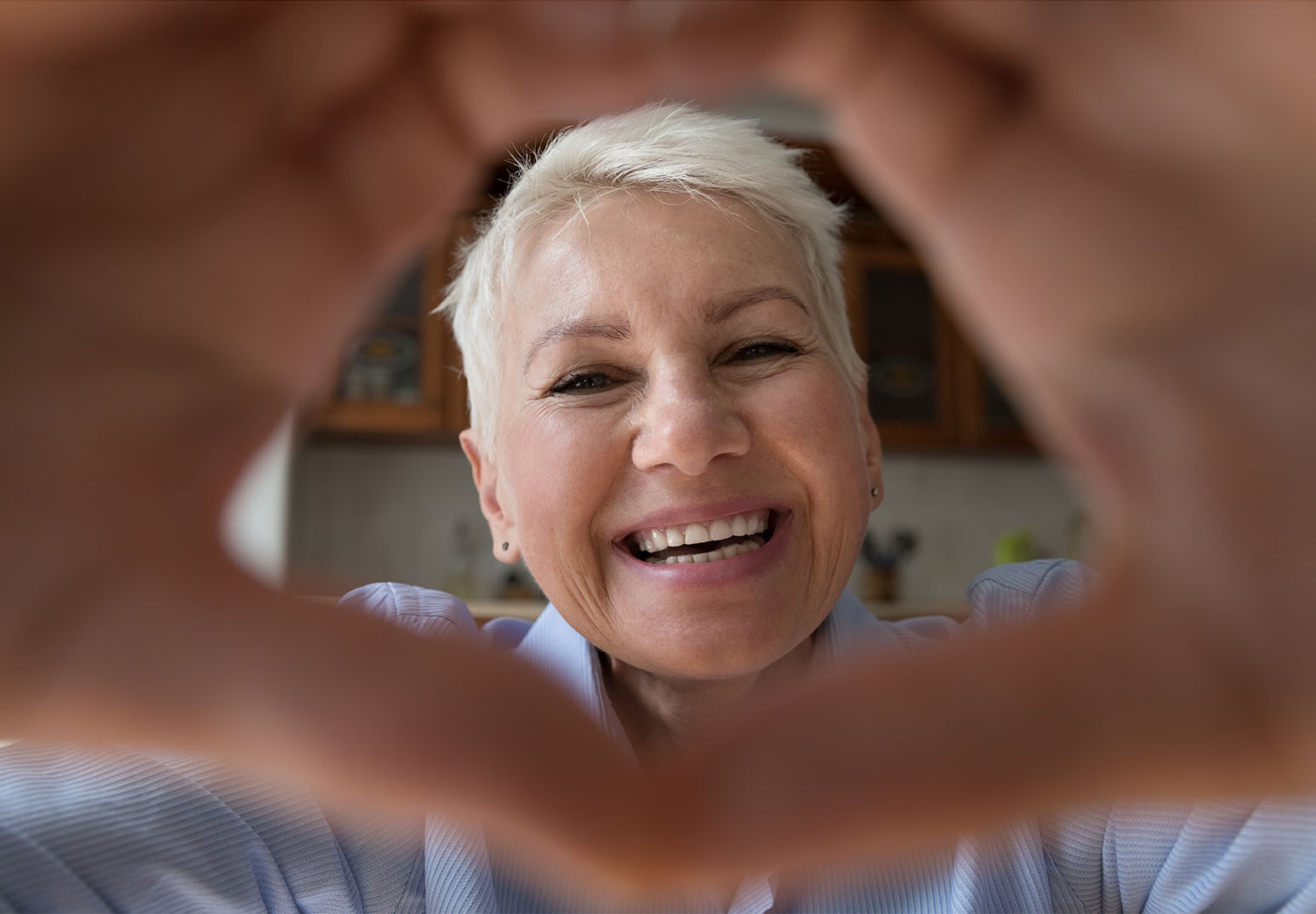 Woman with hands framing face.