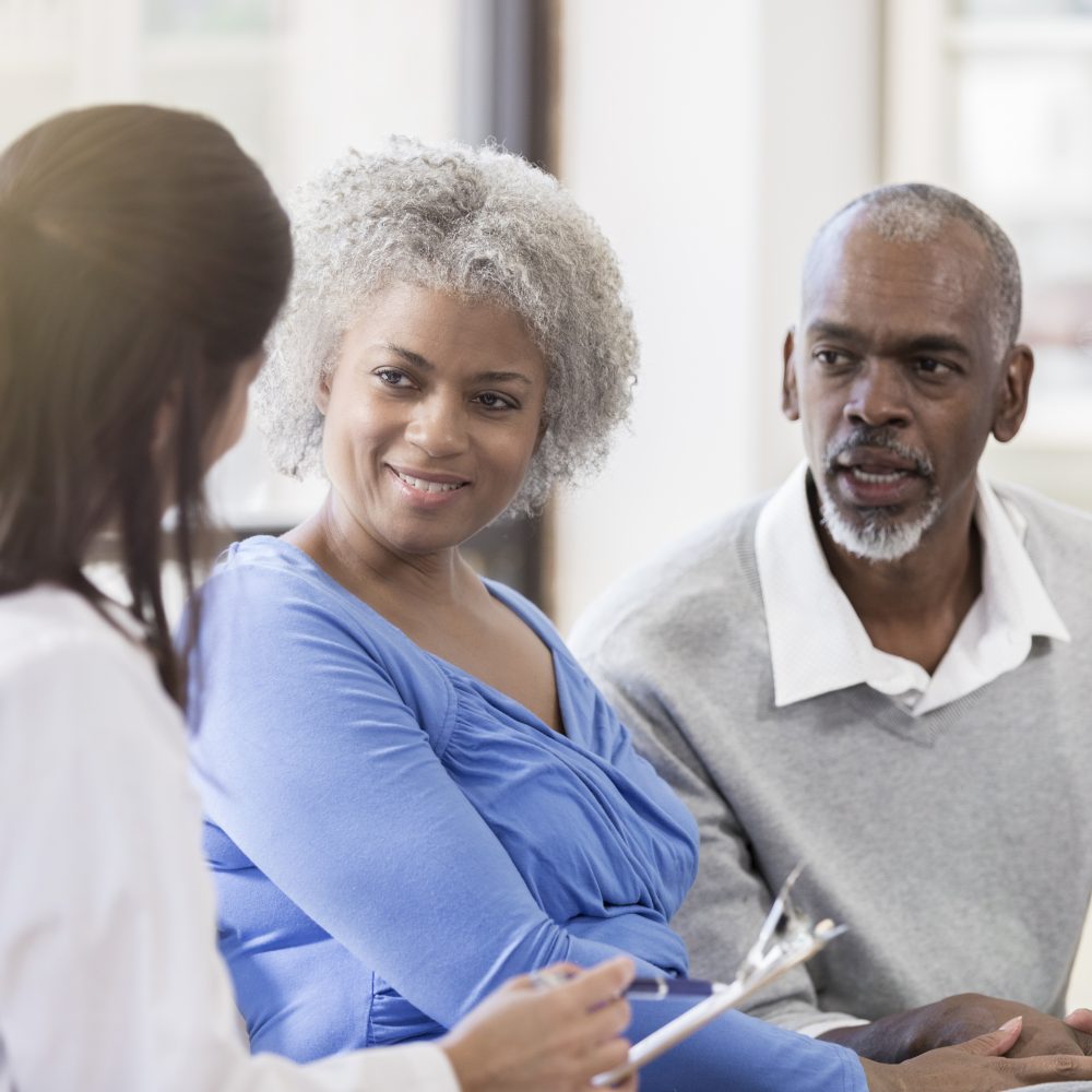 Couple speaking with physician