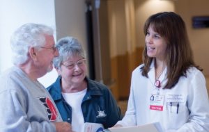 Physician and older couple discussing health information