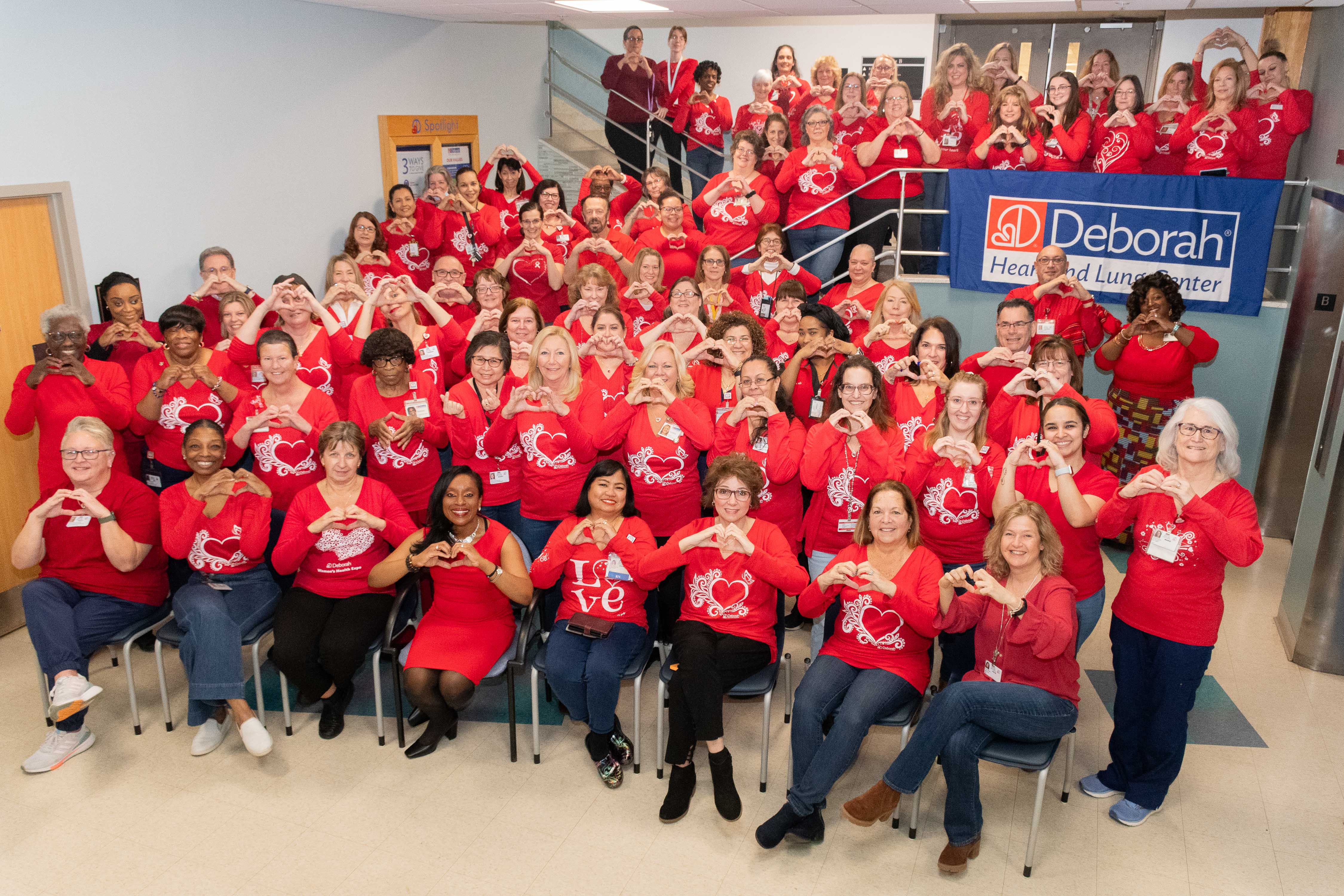 group of hospital employees wearing red t-shirts